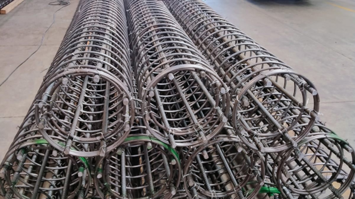 Rows of fabricated steel reinforcing cages laid out in a yard